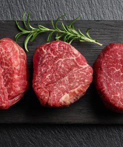 Raw,beef,fillet,steaks,with,rosemary,on,black,wooden,board